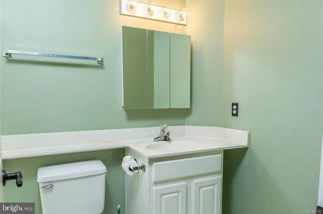 a bathroom with a sink a toilet and mirror