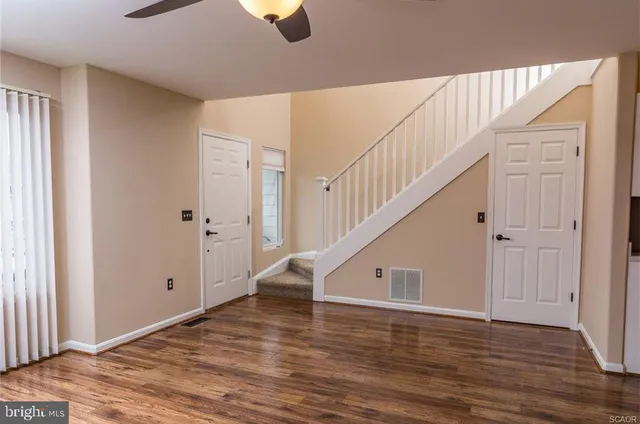 a view of an entryway with wooden floor