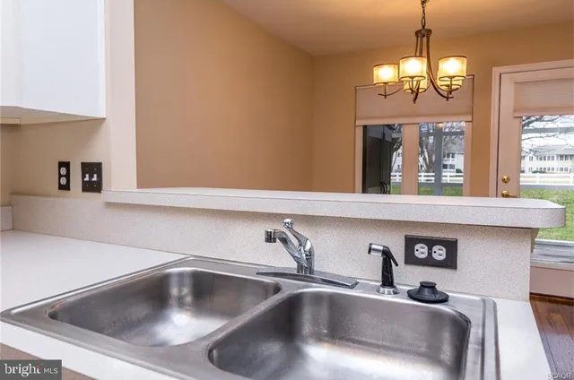 a kitchen with a sink and chandelier