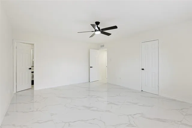 a view of empty room with a fireplace
