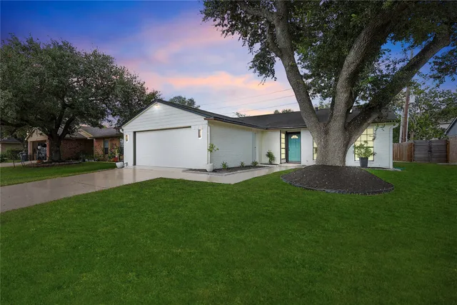 a front view of house with yard and green space