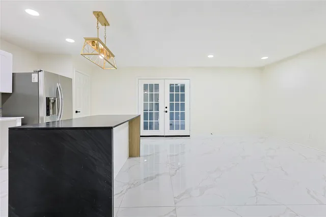 a kitchen with stainless steel appliances a refrigerator and a stove top oven