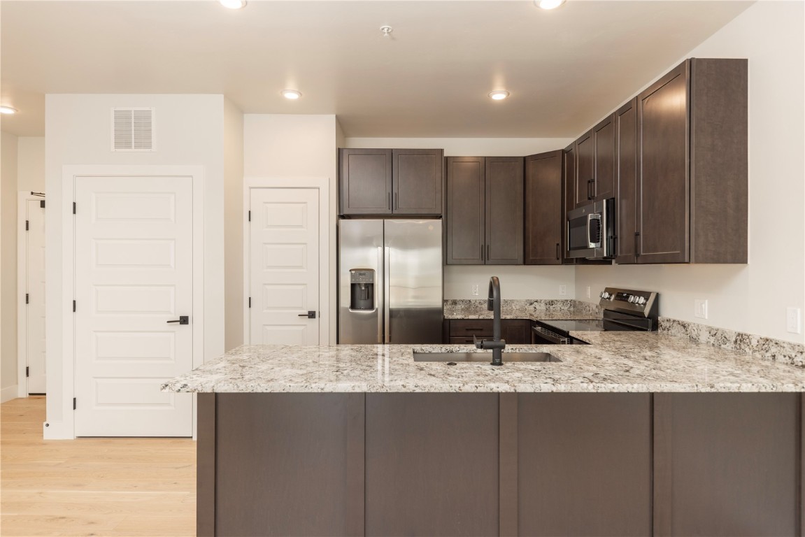 35 Argentine Court, Unit 202 Keystone, CO 80435 - Photo 5 of 34 a kitchen with stainless steel appliances granite countertop a sink and cabinets