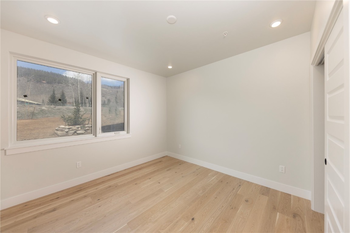 35 Argentine Court, Unit 202 Keystone, CO 80435 - Photo 6 of 34 wooden floor in an empty room with a window