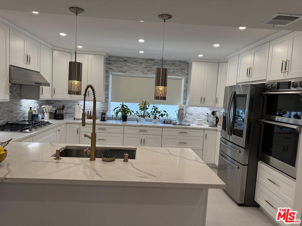 13218 Fiji Way, Unit J Marina del Rey, CA 90292 - Photo 11 of 33 a kitchen with stainless steel appliances granite countertop a sink refrigerator and cabinets