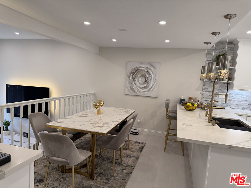 13218 Fiji Way, Unit J Marina del Rey, CA 90292 - Photo 12 of 33 a view of a dining room with furniture and wooden floor