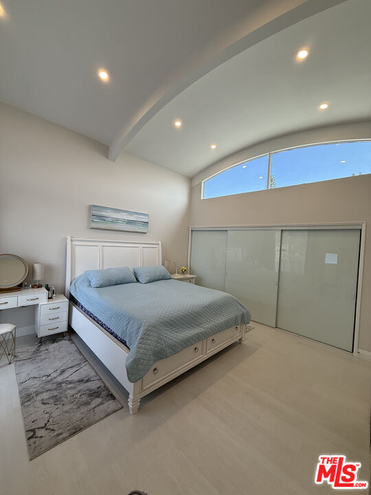 13218 Fiji Way, Unit J Marina del Rey, CA 90292 - Photo 18 of 33 a spacious bedroom with a bed and painting on the wall