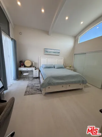 a bedroom with a bed and a couch