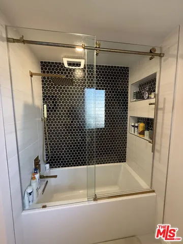 a bathroom with a bathtub and a shower