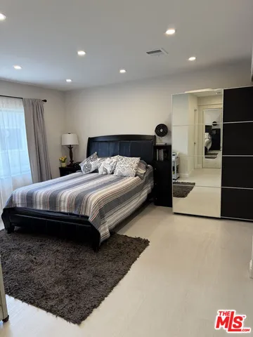 a bedroom with a bed and a walk in closet