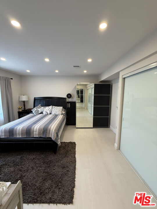 13218 Fiji Way, Unit J Marina del Rey, CA 90292 - Photo 28 of 33 a bed room with a bed and a walk in closet