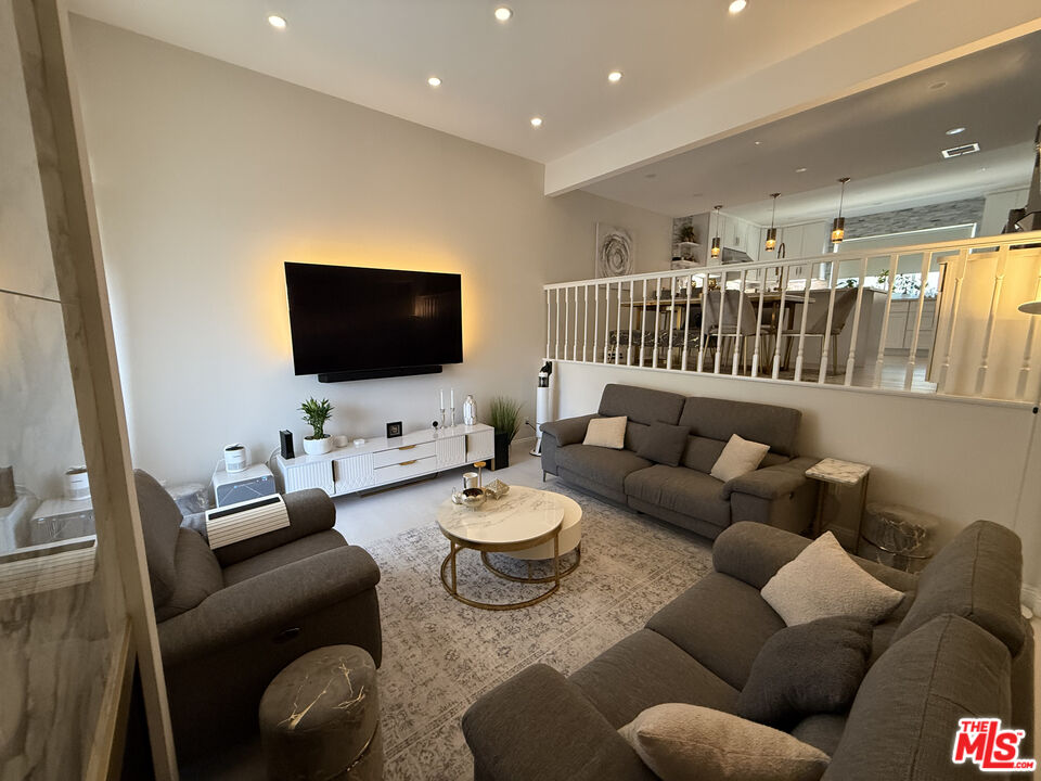 13218 Fiji Way, Unit J Marina del Rey, CA 90292 - Photo 3 of 33 a living room with furniture and a flat screen tv