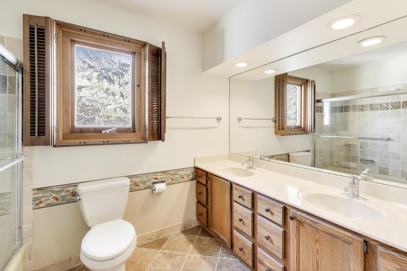 1227 16th Street Wilmette, IL 60091 - Photo 14 of 22 a bathroom with a sink a toilet and mirror
