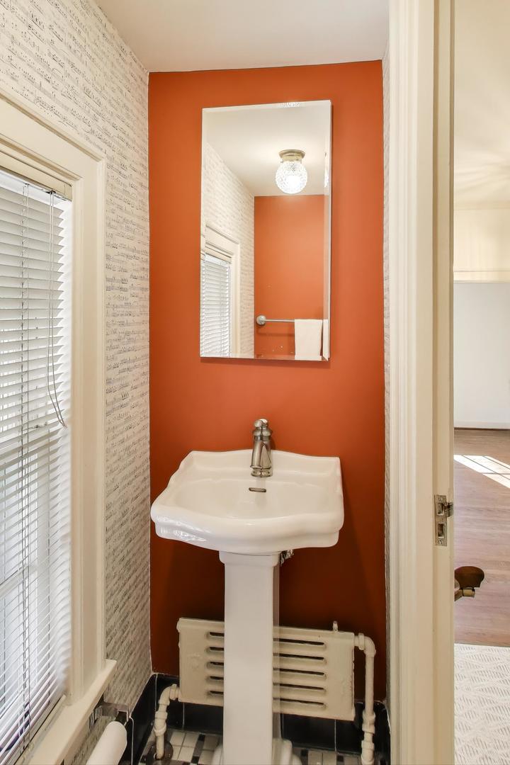 1227 16th Street Wilmette, IL 60091 - Photo 8 of 22 a bathroom with a sink a mirror and a window