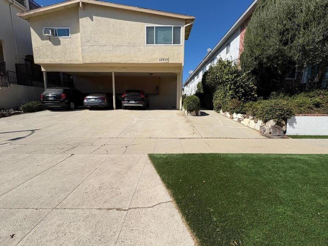 11719 Mayfield Avenue, Unit 6 Los Angeles, CA 90049 - Photo 1 of 20 a view of house with yard