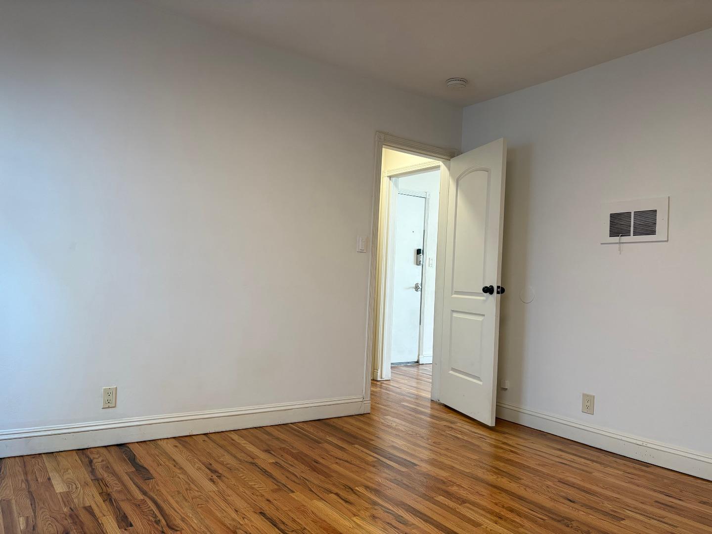 11719 Mayfield Avenue, Unit 6 Los Angeles, CA 90049 - Photo 16 of 20 a view of an empty room with wooden floor and closet