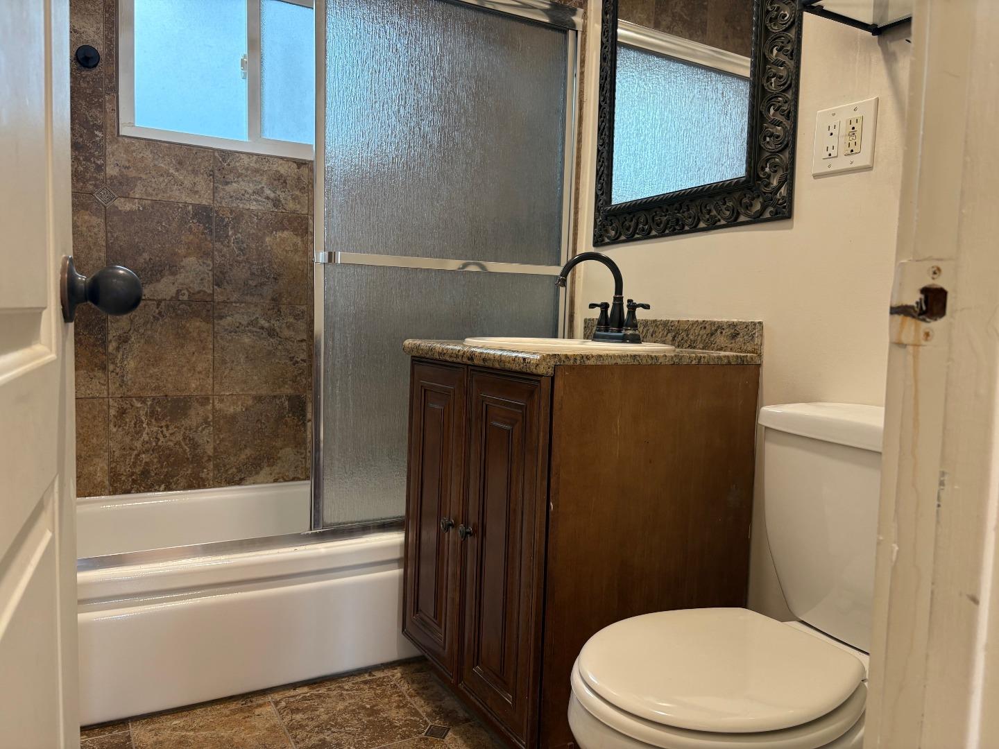 11719 Mayfield Avenue, Unit 6 Los Angeles, CA 90049 - Photo 19 of 20 a bathroom with a toilet a sink and bathtub