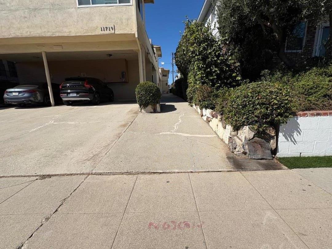 11719 Mayfield Avenue, Unit 6 Los Angeles, CA 90049 - Photo 3 of 20 a view of garage with a car parked in it