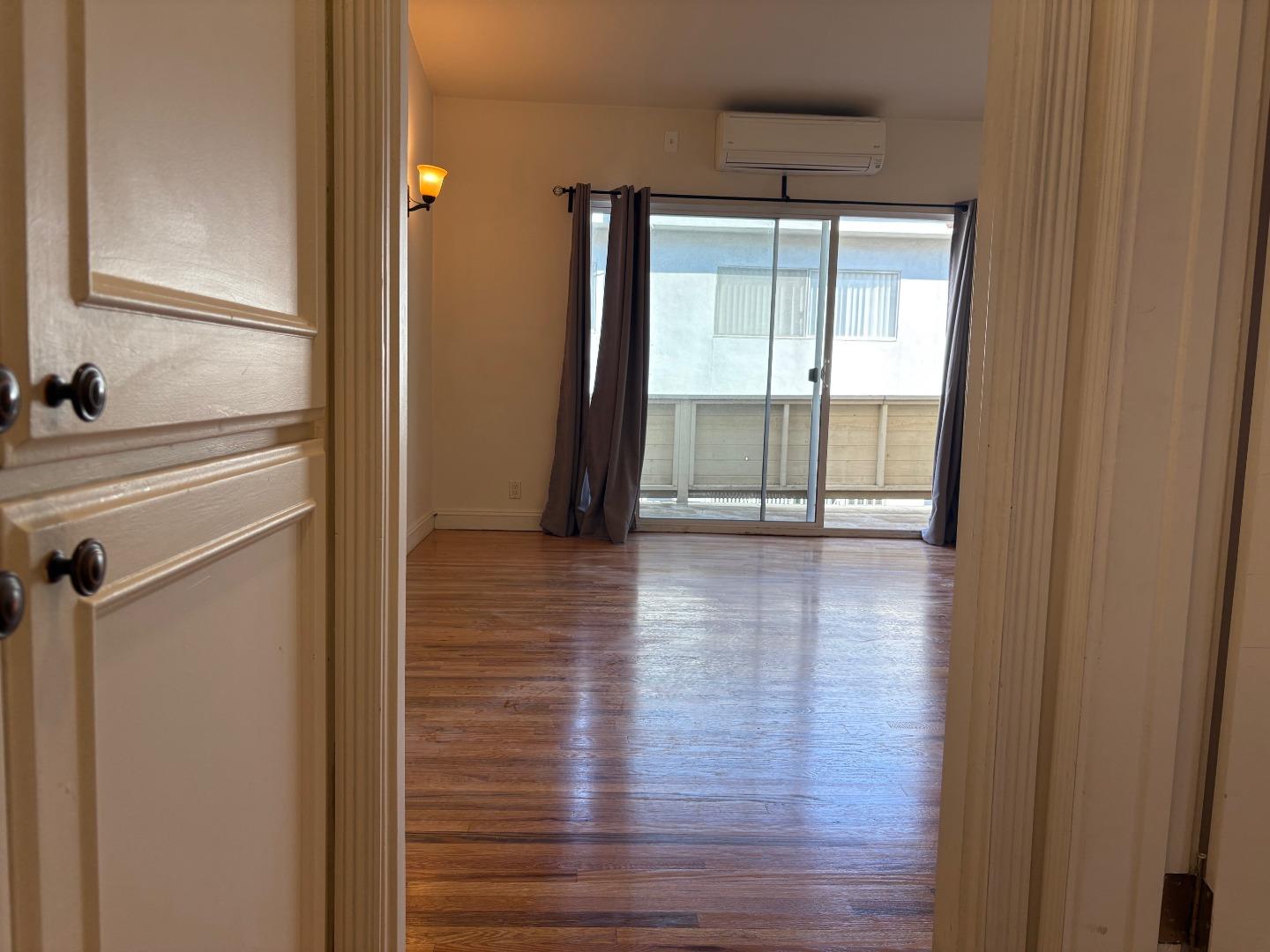 11719 Mayfield Avenue, Unit 6 Los Angeles, CA 90049 - Photo 9 of 20 a view of a room with wooden floor and windows