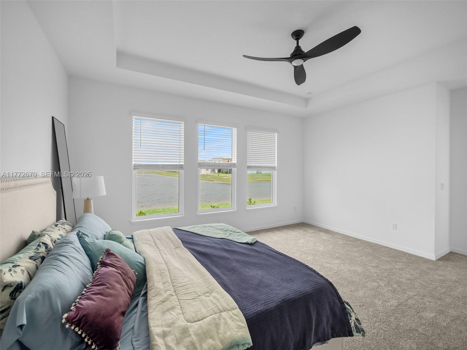 516 Ranch Oak Circle Port St. Lucie, FL 34984 - Photo 21 of 44 a bedroom with a bed a window and a chandelier