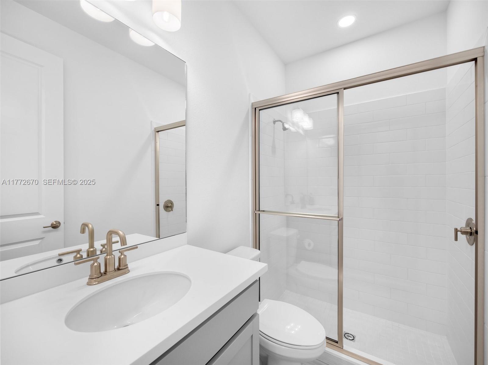 516 Ranch Oak Circle Port St. Lucie, FL 34984 - Photo 23 of 44 a bathroom with a sink toilet and shower