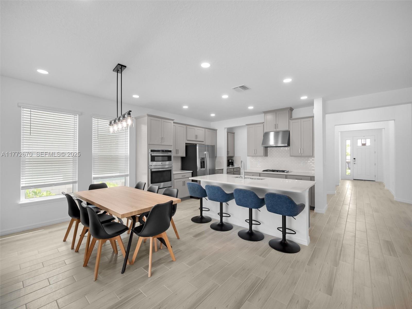 516 Ranch Oak Circle Port St. Lucie, FL 34984 - Photo 29 of 44 a dining hall with stainless steel appliances a dining table chairs and window