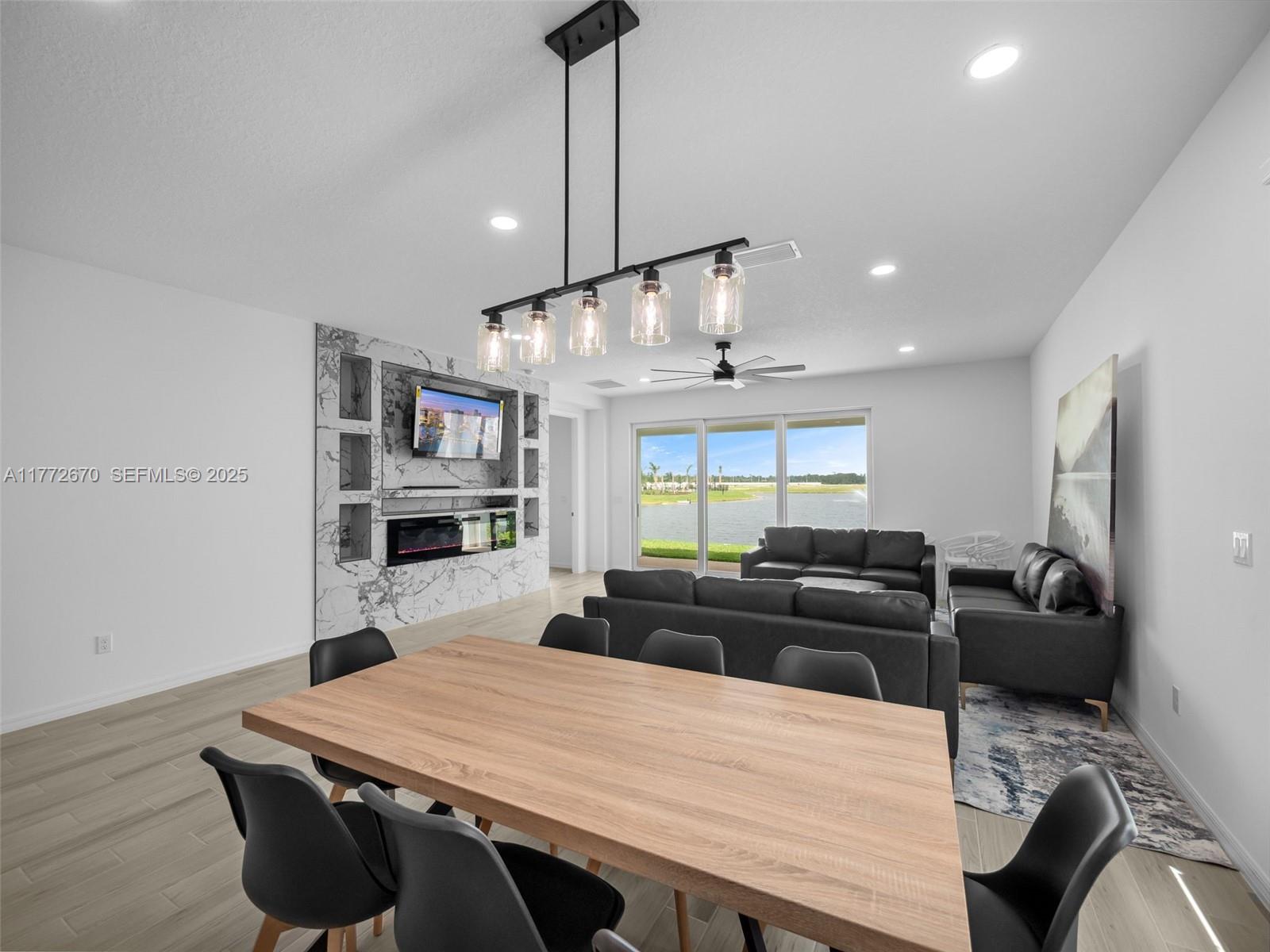 516 Ranch Oak Circle Port St. Lucie, FL 34984 - Photo 31 of 44 a kitchen with stainless steel appliances kitchen island granite countertop a table chairs in it and wooden floors