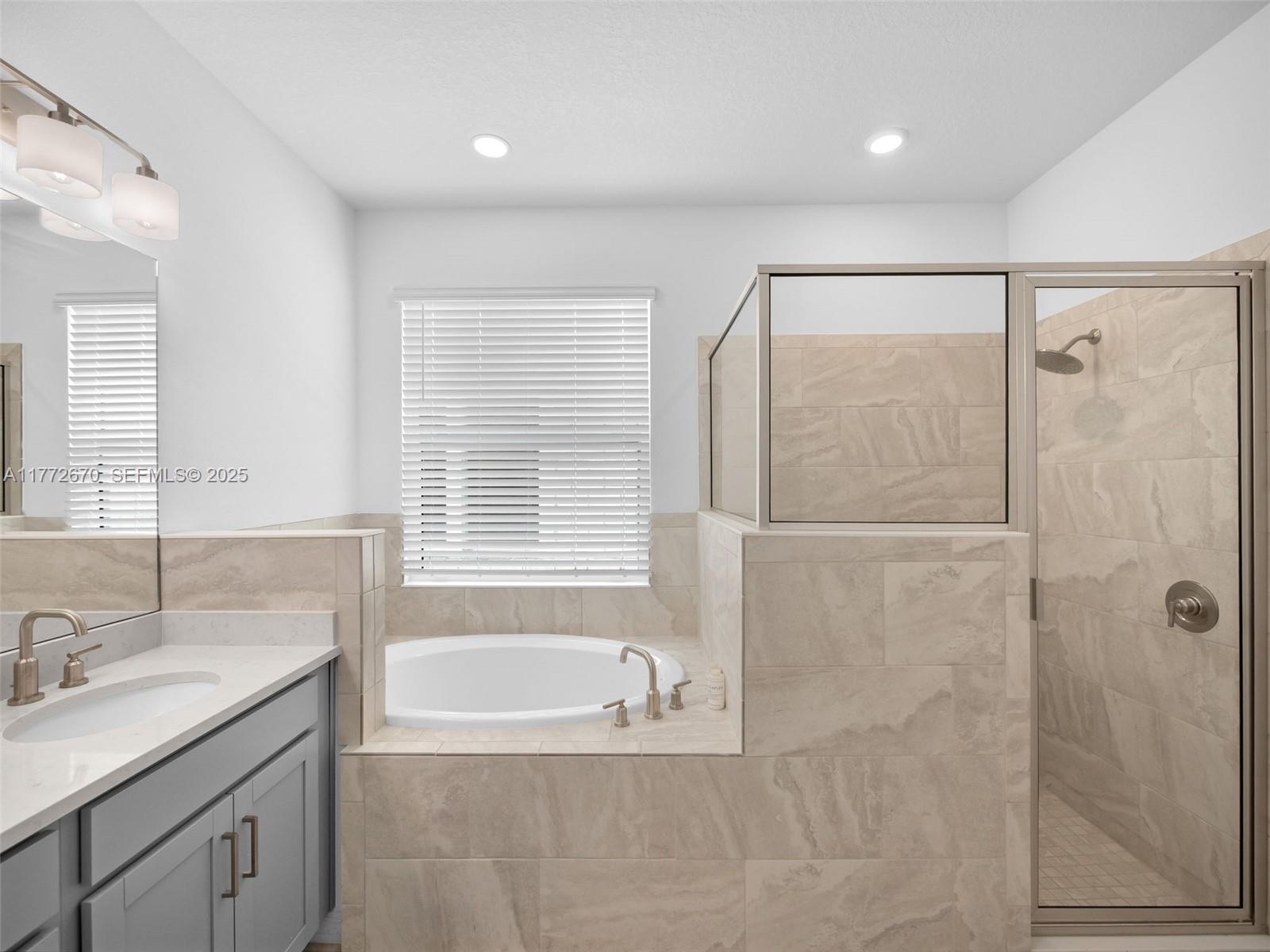 516 Ranch Oak Circle Port St. Lucie, FL 34984 - Photo 33 of 44 a spacious bathroom with a granite countertop sink a bathtub and shower