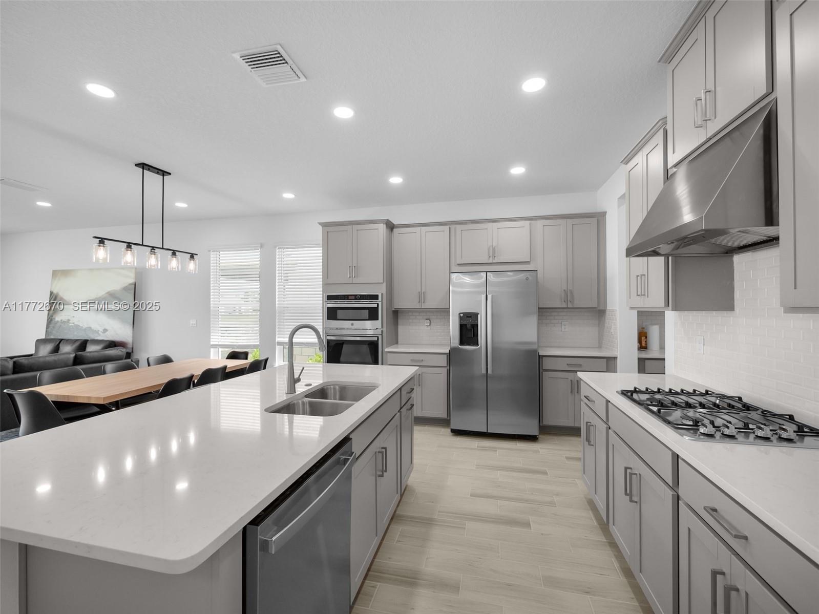 516 Ranch Oak Circle Port St. Lucie, FL 34984 - Photo 34 of 44 a large kitchen with stainless steel appliances a sink a stove a refrigerator and a oven