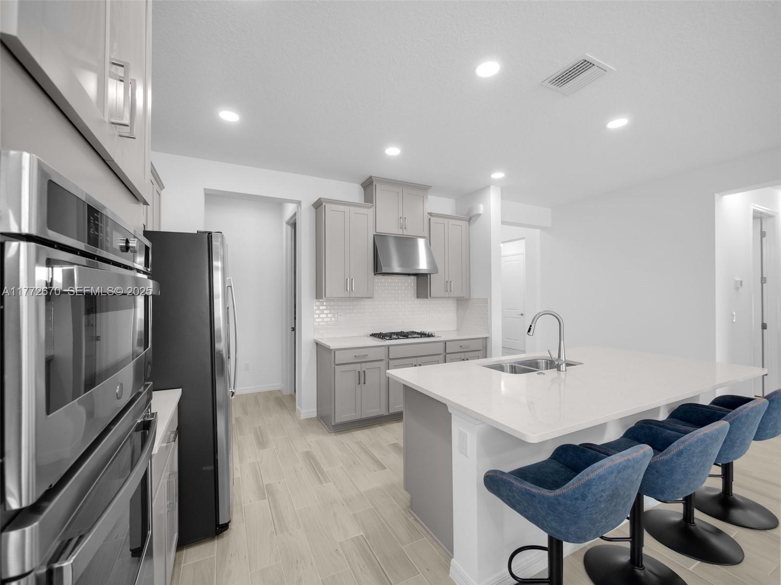 516 Ranch Oak Circle Port St. Lucie, FL 34984 - Photo 36 of 44 a kitchen with cabinets and chairs