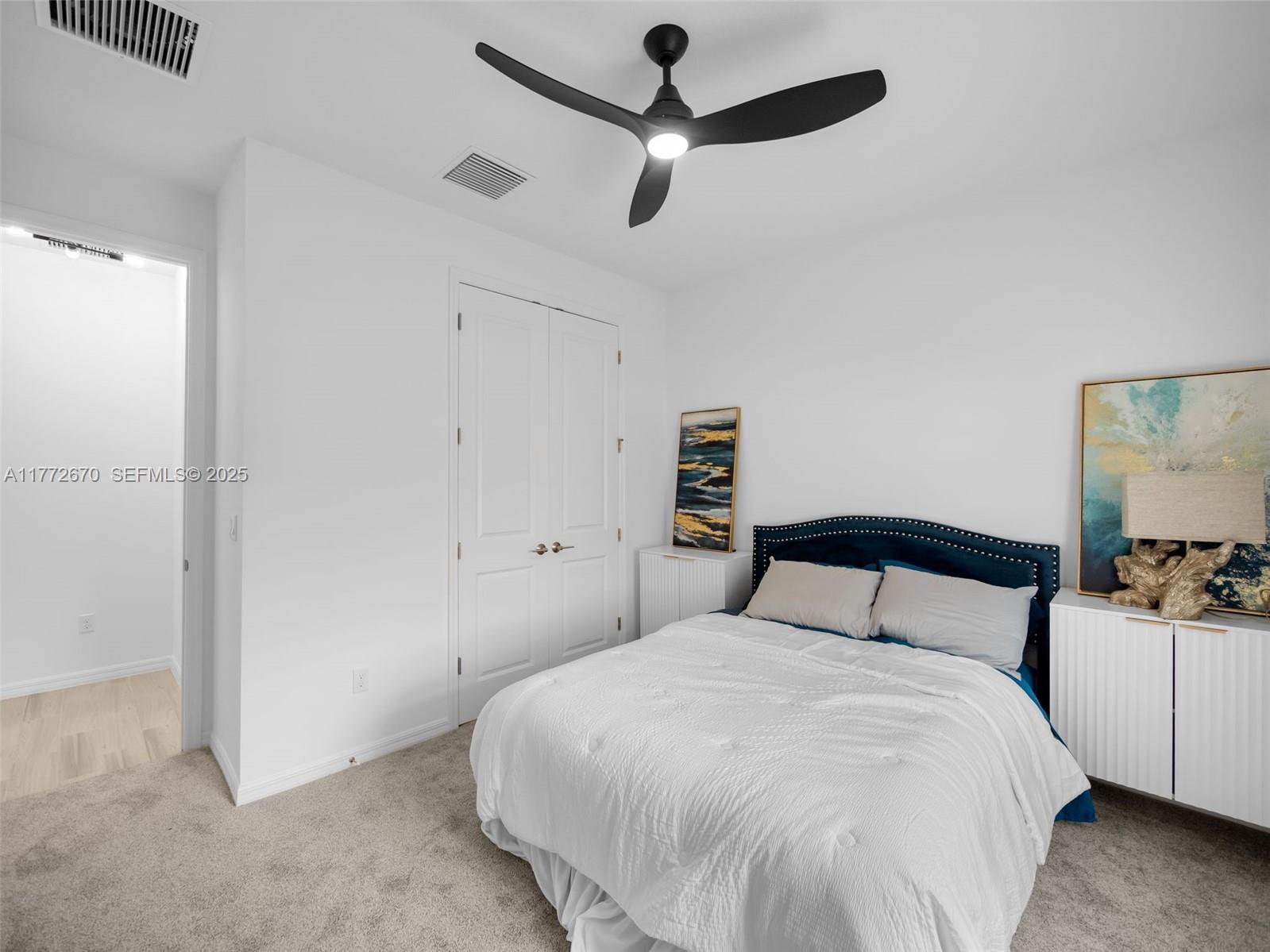 516 Ranch Oak Circle Port St. Lucie, FL 34984 - Photo 37 of 44 a bedroom with a bed and a chandelier