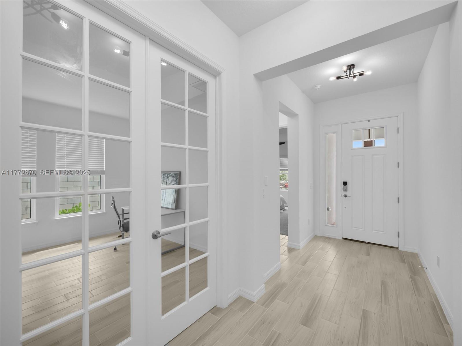 516 Ranch Oak Circle Port St. Lucie, FL 34984 - Photo 6 of 44 a view of an empty room with wooden floor and a window