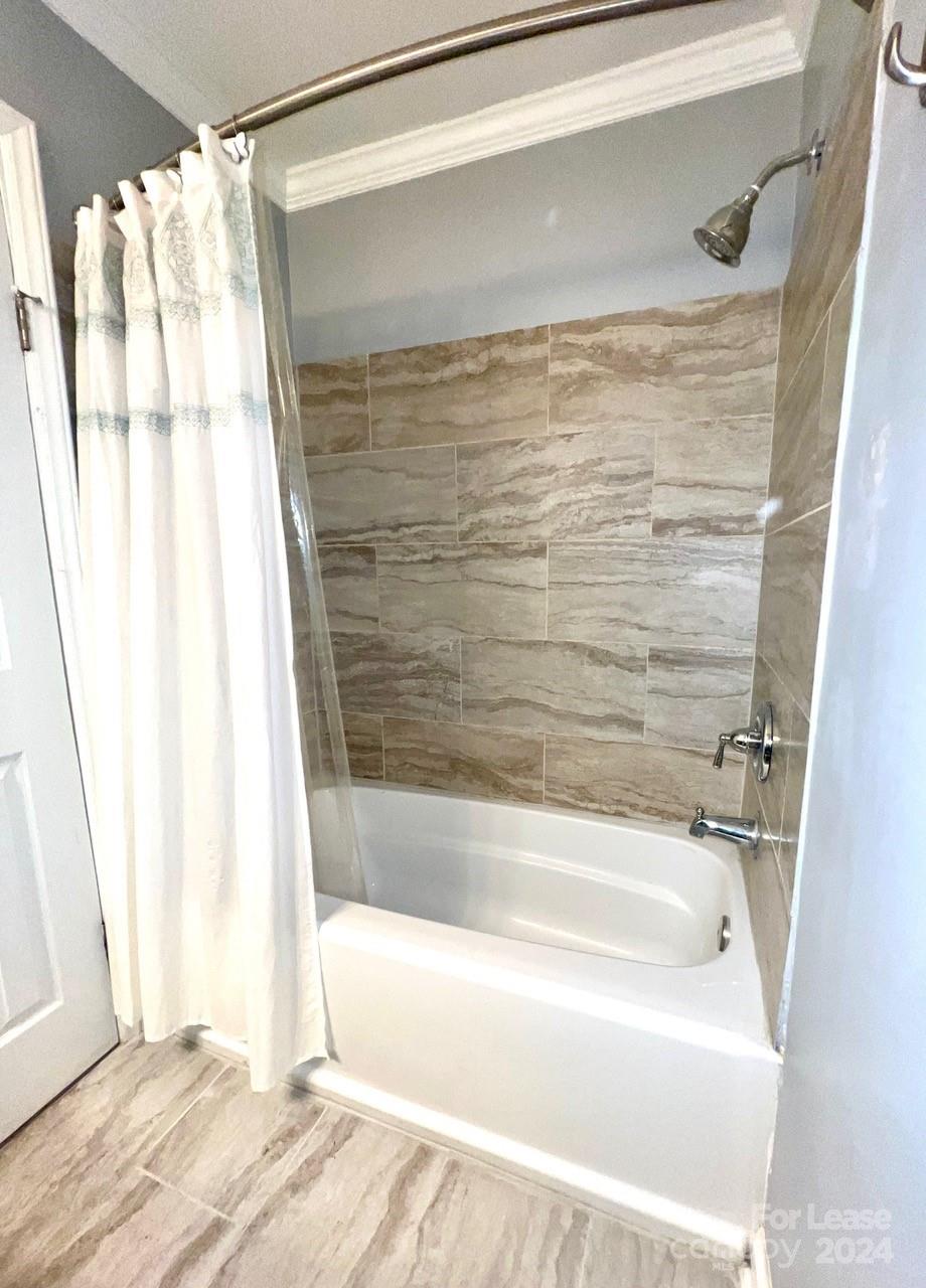 6334 Beecher Drive Charlotte, NC 28215 - Photo 14 of 27 a bathroom with a shower and a bath tub