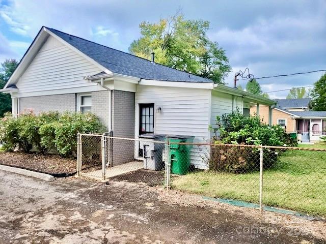 6334 Beecher Drive Charlotte, NC 28215 - Photo 23 of 27 a view of a white house next to a yard and potted plants