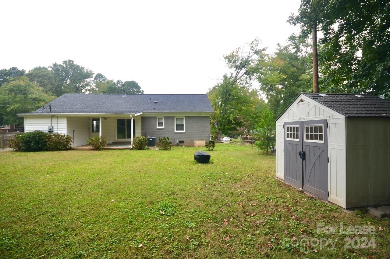 6334 Beecher Drive Charlotte, NC 28215 - Photo 25 of 27 a view of a house with a yard