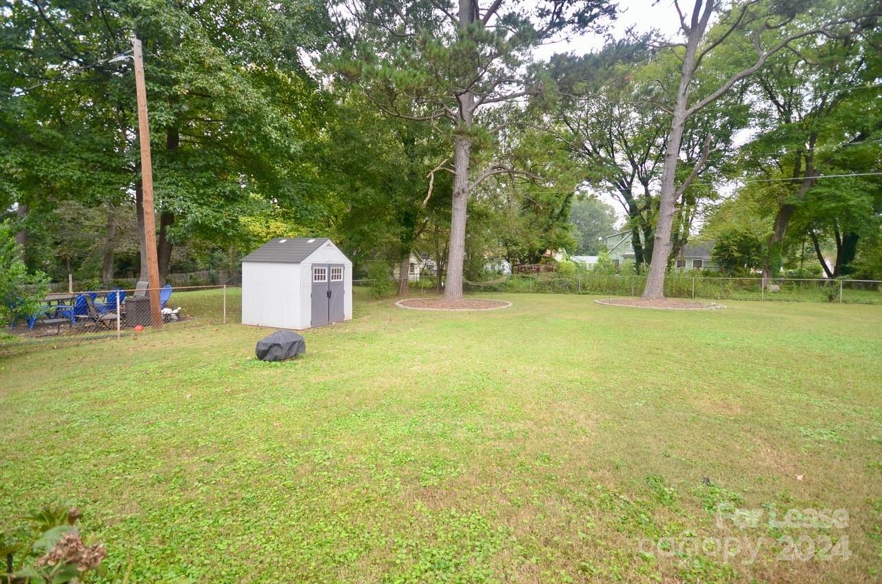 6334 Beecher Drive Charlotte, NC 28215 - Photo 26 of 27 a backyard of a house with table and chairs