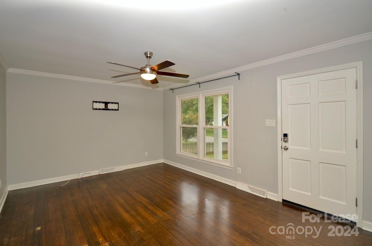 6334 Beecher Drive Charlotte, NC 28215 - Photo 4 of 27 an empty room with wooden floor and windows
