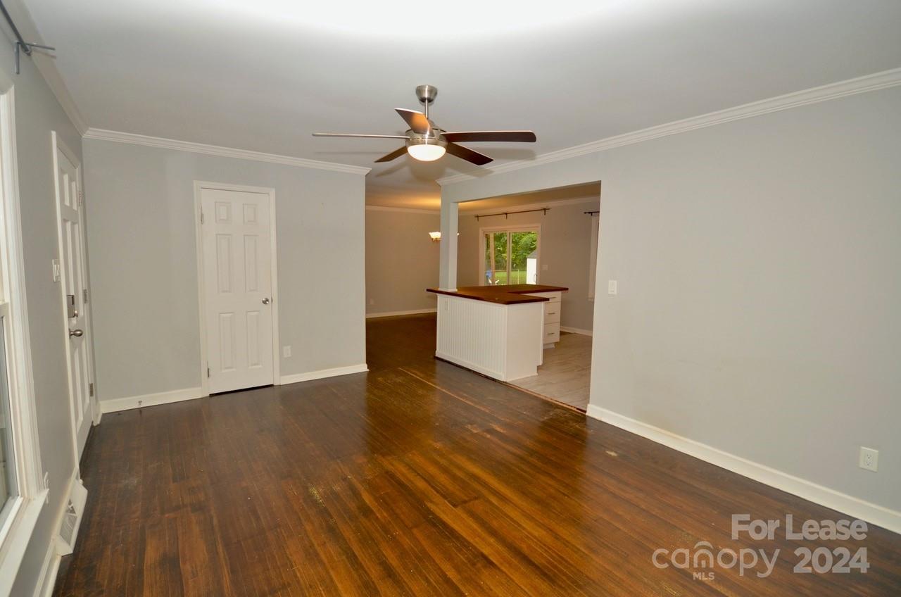 6334 Beecher Drive Charlotte, NC 28215 - Photo 5 of 27 a view of a livingroom with wooden floor and a ceiling fan