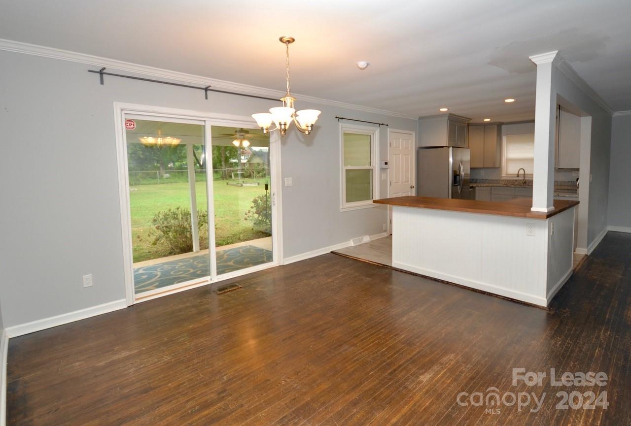6334 Beecher Drive Charlotte, NC 28215 - Photo 6 of 27 a view of a big room with wooden floor and windows
