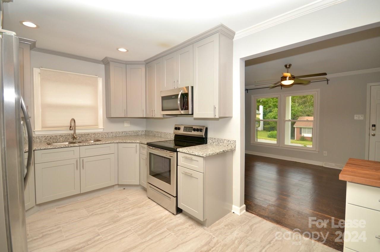 6334 Beecher Drive Charlotte, NC 28215 - Photo 7 of 27 a kitchen with appliances cabinets and a sink