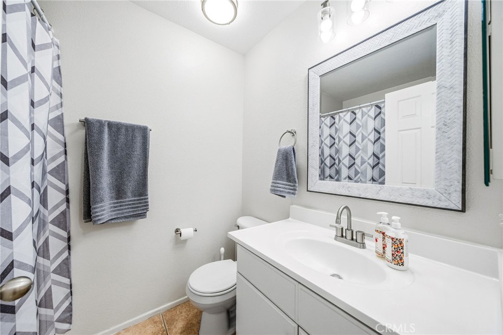 33656 Winston Way, Unit A Temecula, CA 92592 - Photo 15 of 46 a bathroom with a sink toilet and mirror