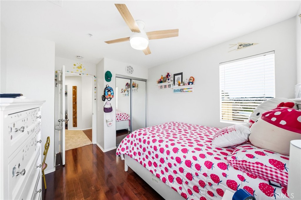 33656 Winston Way, Unit A Temecula, CA 92592 - Photo 29 of 46 a bedroom with a bed and a wooden floor