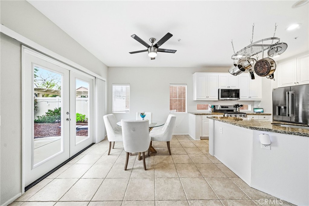 33656 Winston Way, Unit A Temecula, CA 92592 - Photo 3 of 46 a view of a dining room with furniture a kitchen a chandelier and wooden floor