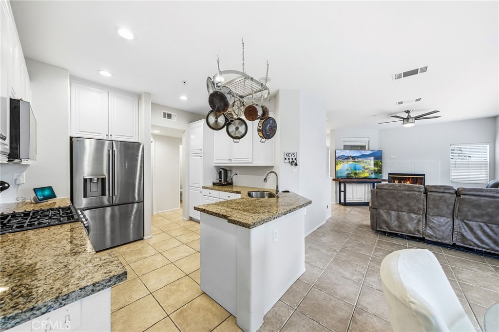 33656 Winston Way, Unit A Temecula, CA 92592 - Photo 7 of 46 a kitchen with stainless steel appliances granite countertop a sink and a refrigerator