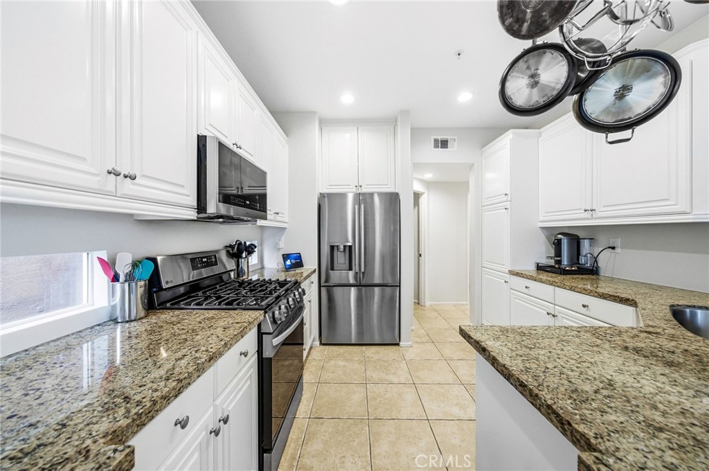 33656 Winston Way, Unit A Temecula, CA 92592 - Photo 8 of 46 a kitchen with stainless steel appliances granite countertop a sink a stove and cabinets