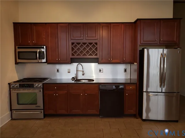 a kitchen with a sink a stove and refrigerator