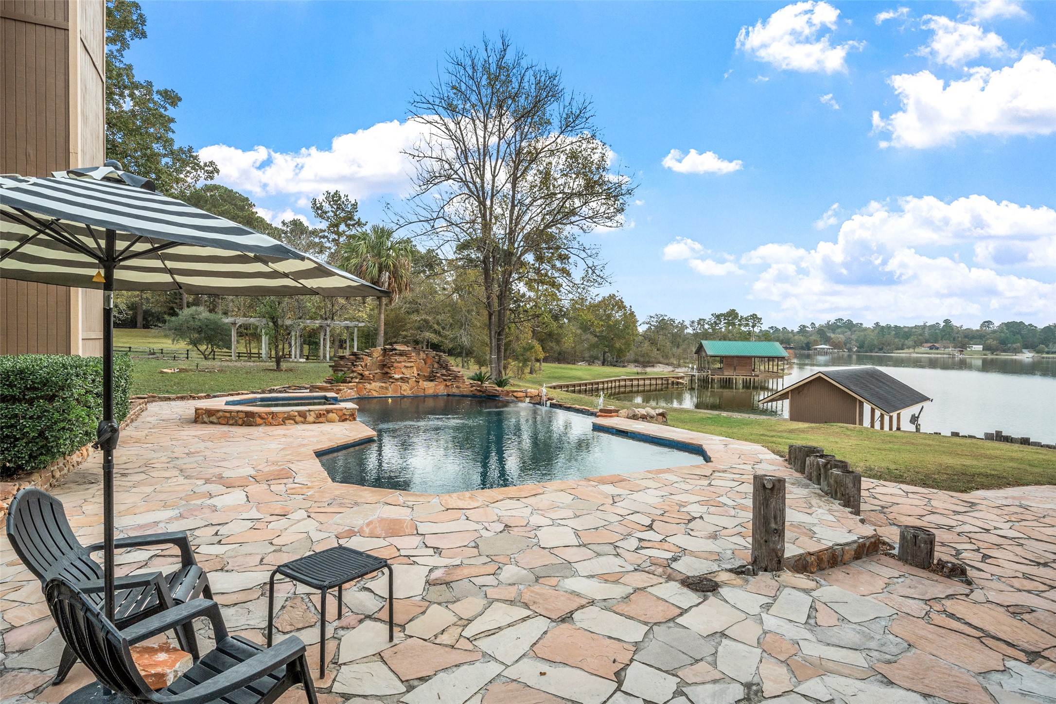 186 Lake Road Huntsville, TX 77320 - Photo 1 of 48 a view of a swimming pool with a lounge chairs