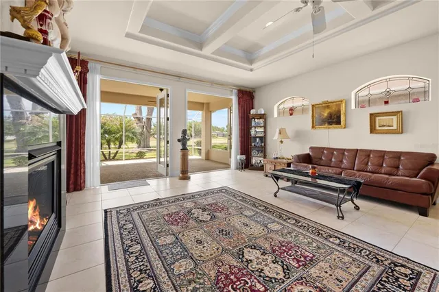 a living room with furniture and a floor to ceiling window