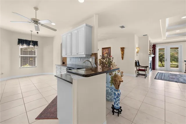 a kitchen with granite countertop a stove a sink and a refrigerator