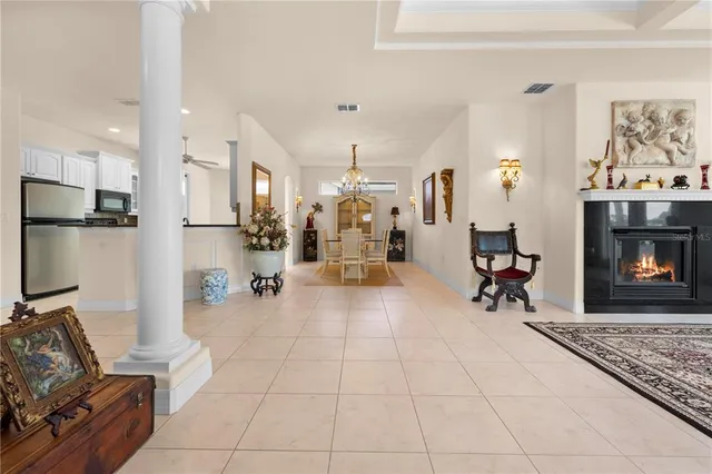 a view of a dining room with wooden floor chandelier and windows